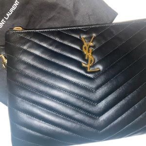 Black Yves Saint Laurent pouch wristlet. Gold-toned metal hardware.